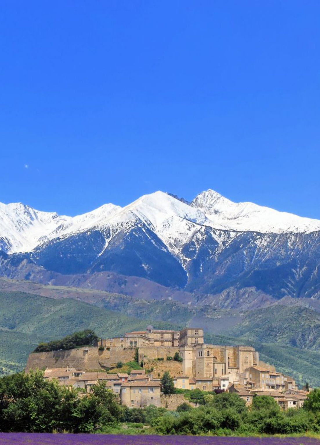 à l’arrière-plan : des montagnes ; au premier plan : un village