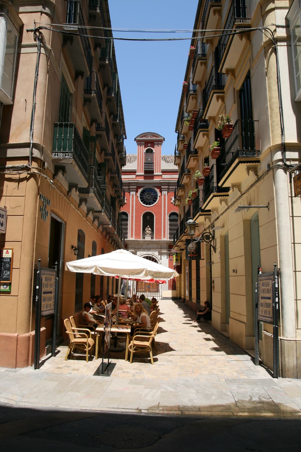 une terrasse de café ombragée avec des parasols